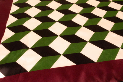 Close-up detail of geometric chevron pattern on luxury silk charmeuse