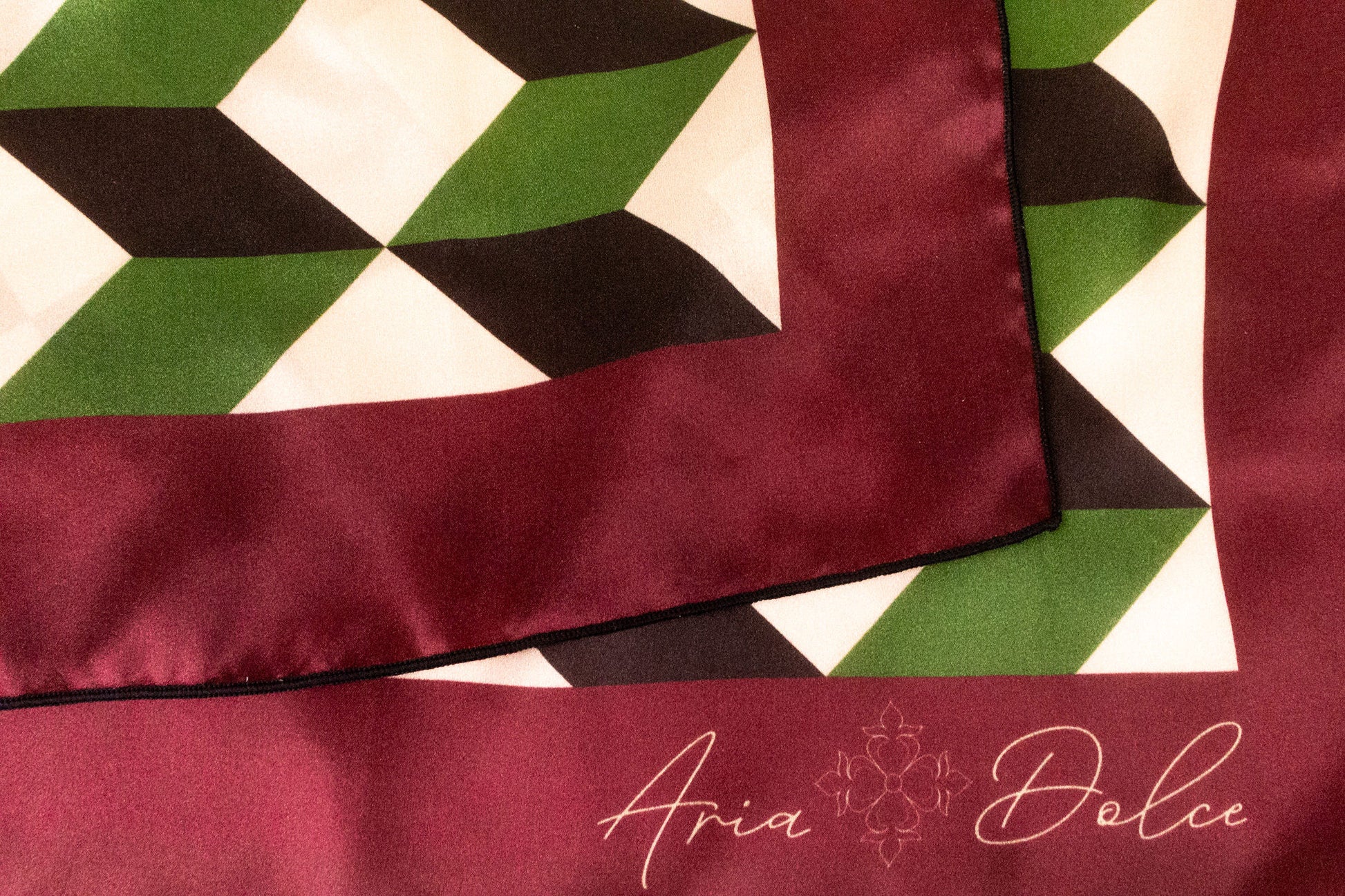 Silk charmeuse fabric with hand-rolled hem detail on chevron scarf