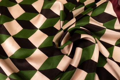 Close-up of geometric chevron silk scarf twisted to display the cathedral-inspired pattern