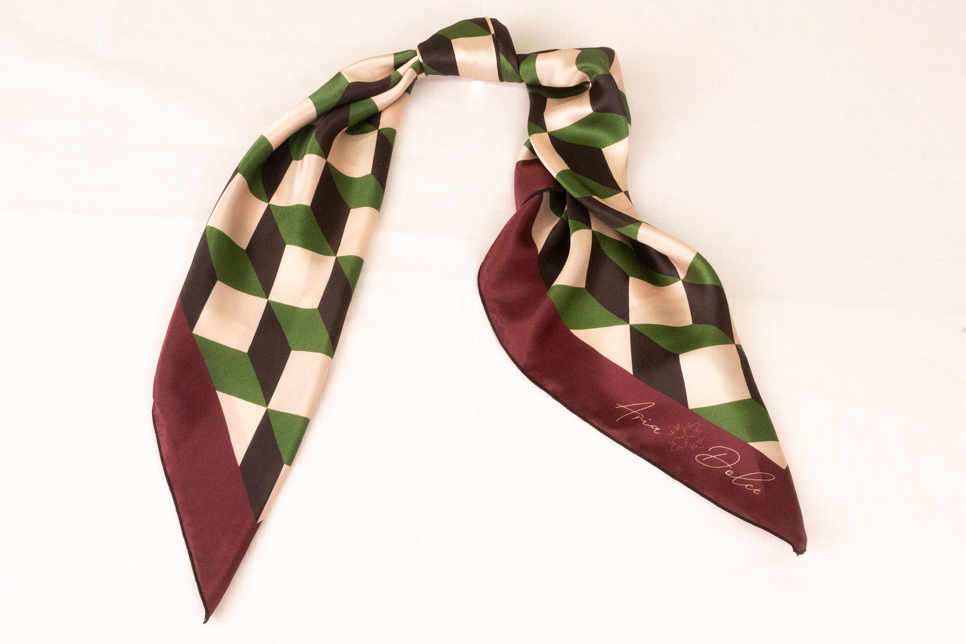 Geometric pattern scarf styled as handbag accessory accent piece