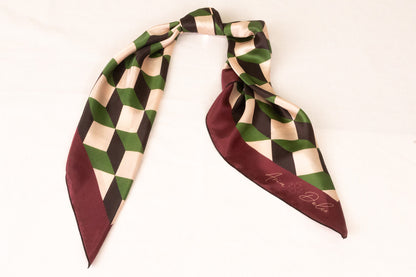 Geometric pattern scarf styled as handbag accessory accent piece