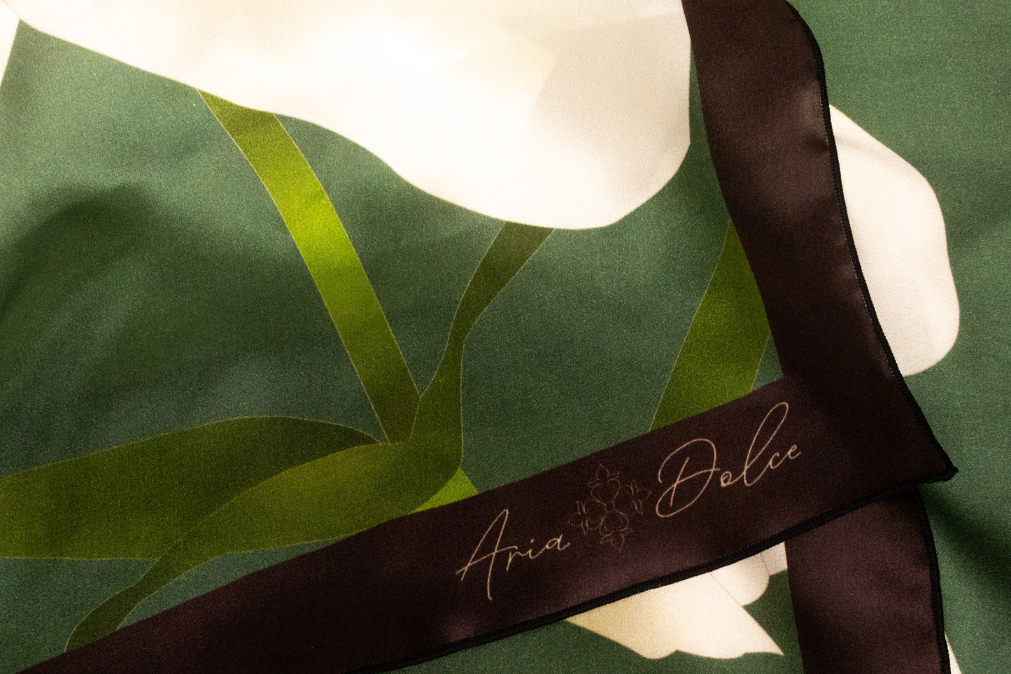 Silk charmeuse texture with hand-rolled hem detail on lily scarf