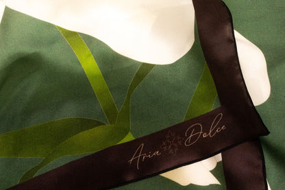 Silk charmeuse texture with hand-rolled hem detail on lily scarf