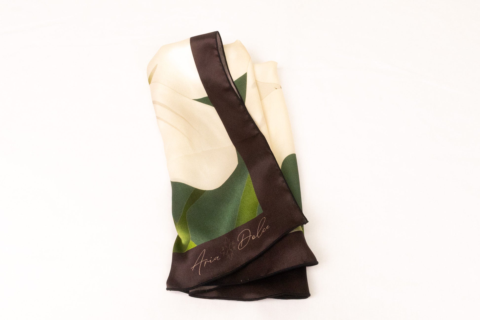 Green and white botanical lily scarf folded display showing sacred symbolism