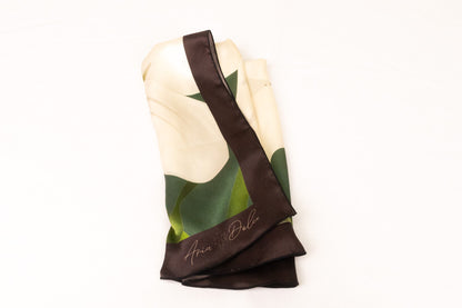 Green and white botanical lily scarf folded display showing sacred symbolism