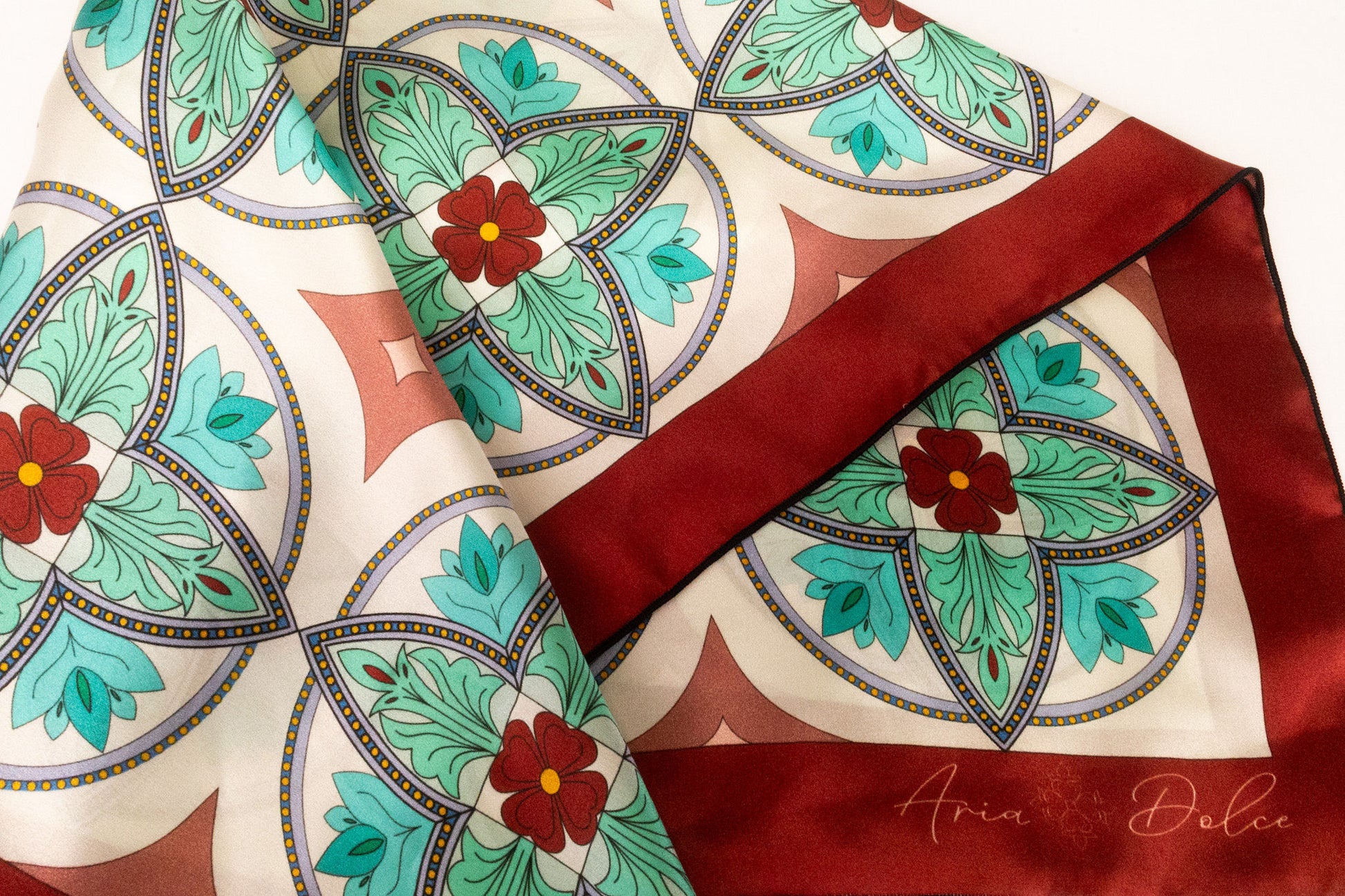 Silk charmeuse fabric with hand-rolled hem on turquoise mosaic scarf