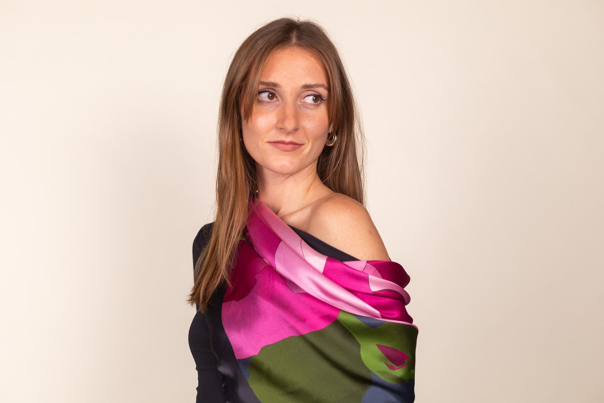 Green and pink silk scarf draped elegantly over shoulders