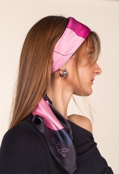 Pink and green silk square scarf styled as hair accessory
