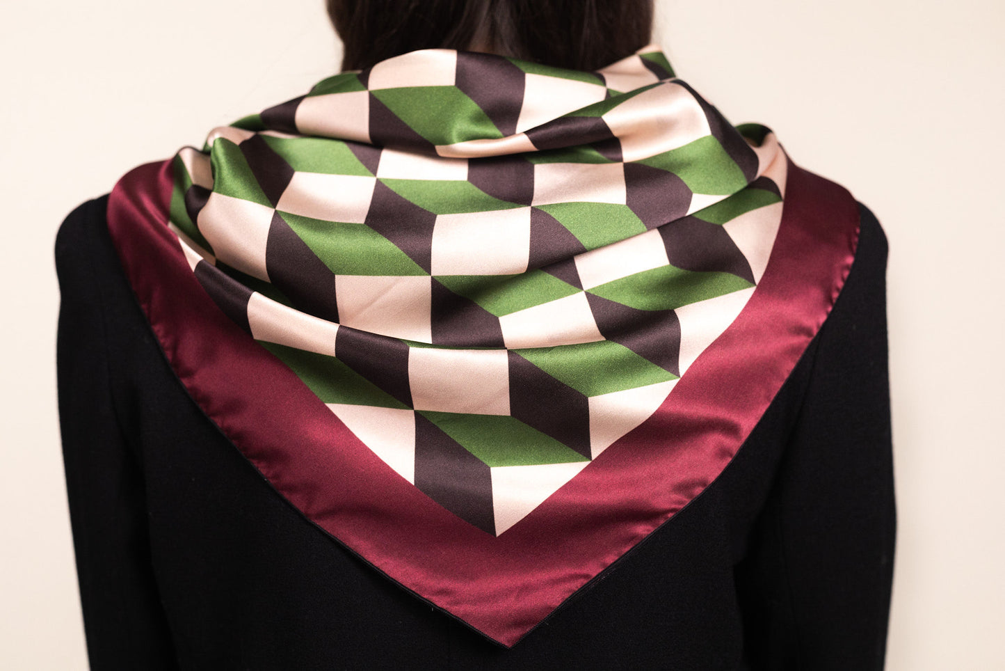 Architectural silk scarf with chevron stripes draped over shoulders