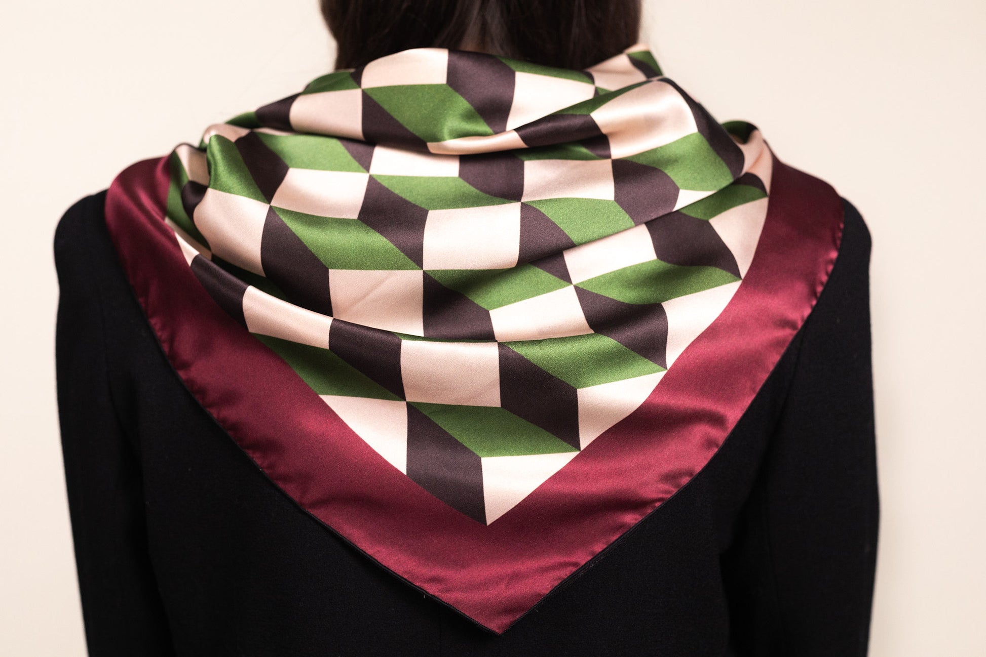 Architectural silk scarf with chevron stripes draped over shoulders