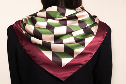 Architectural silk scarf with chevron stripes draped over shoulders