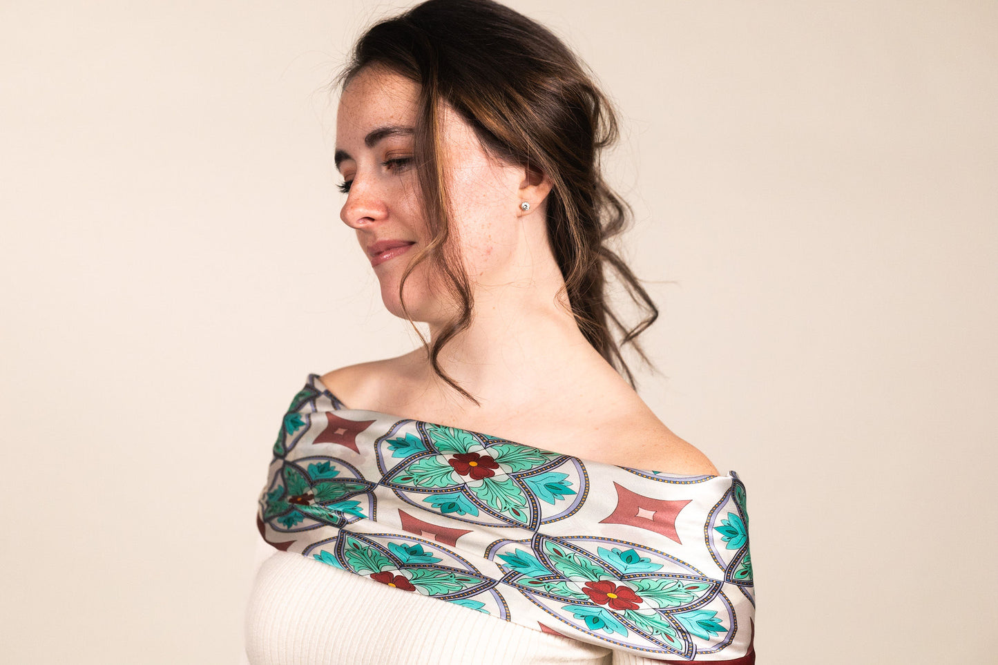 Turquoise and blue mosaic scarf styled elegantly over shoulders