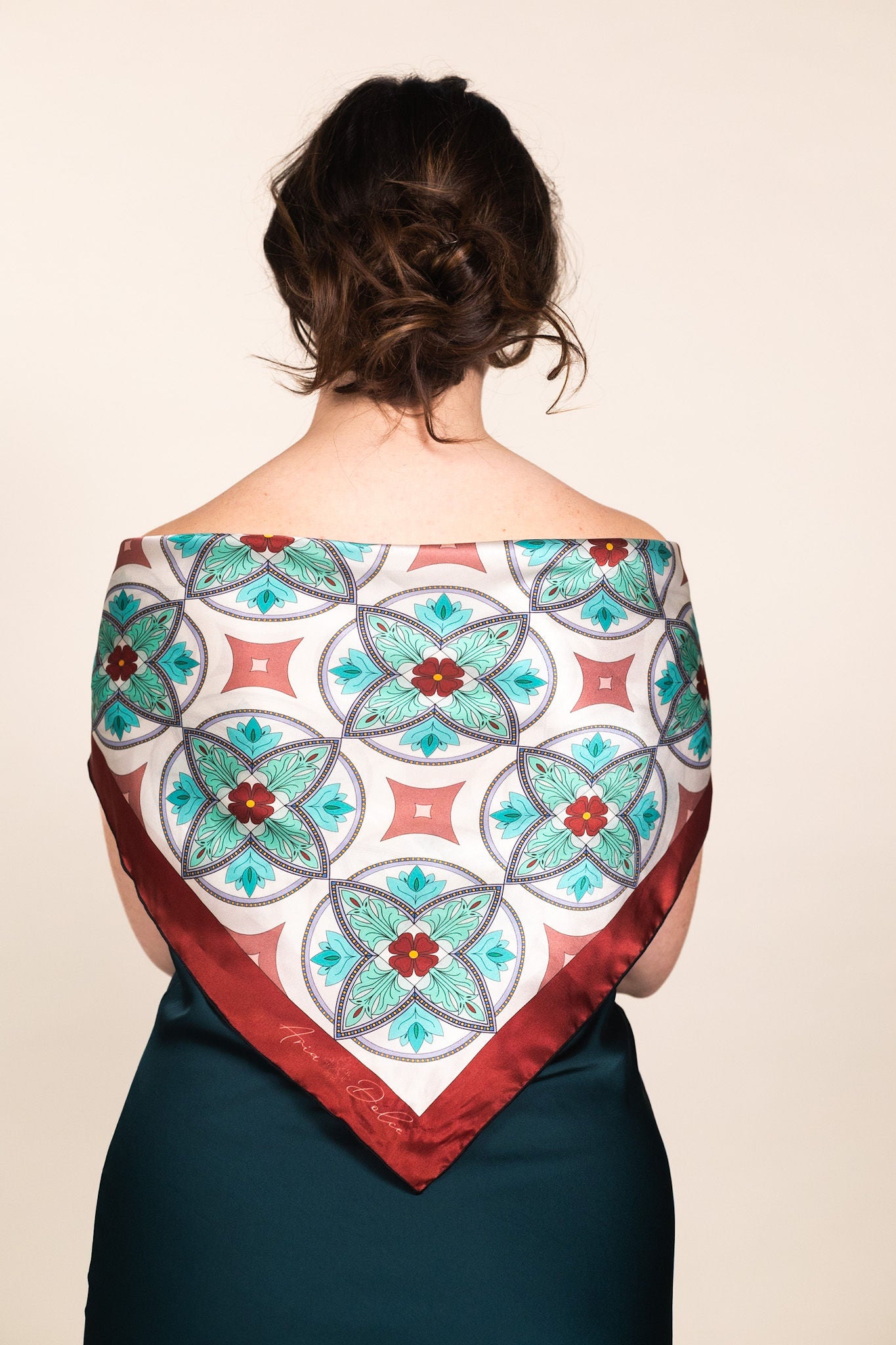 Woman wearing turquoise silk scarf draped over shoulders