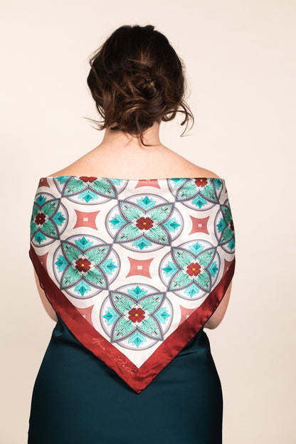Woman wearing turquoise silk scarf draped over shoulders