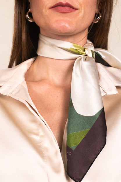 Close-up of green and white lily scarf styled elegantly around neck