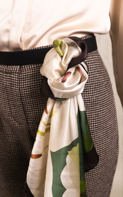 Elegant white silk scarf with green lily blooms styled for everyday wear